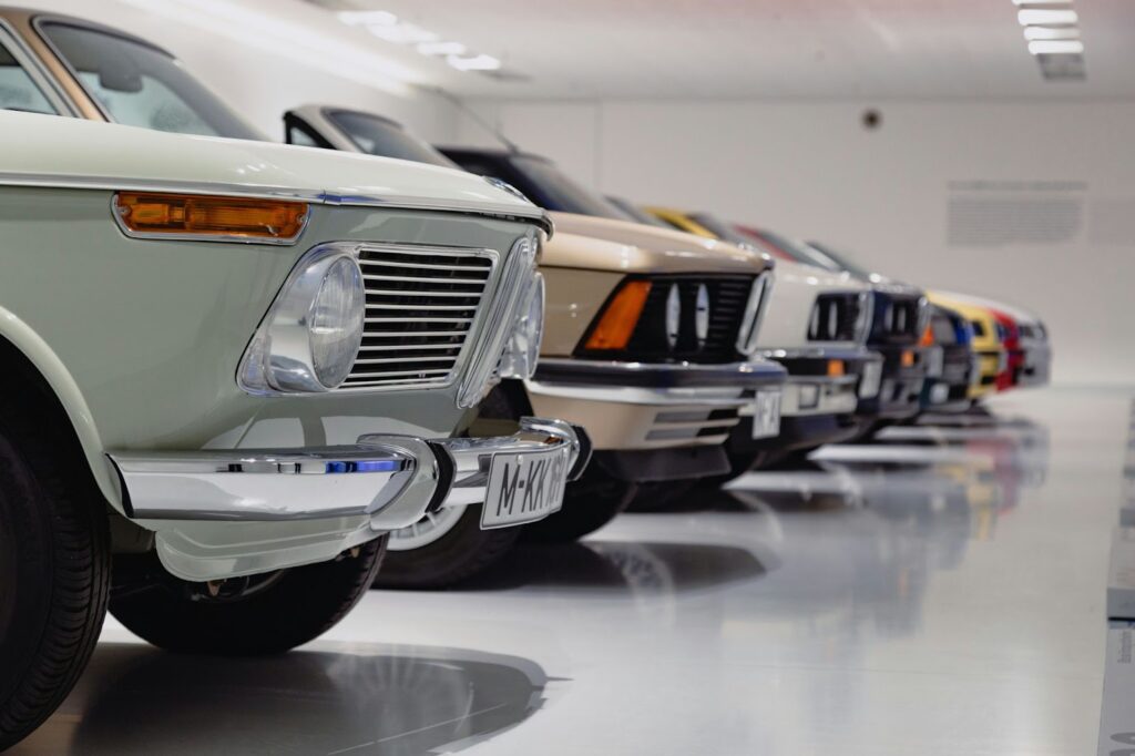 Vintage cars lined up in a storage facility.