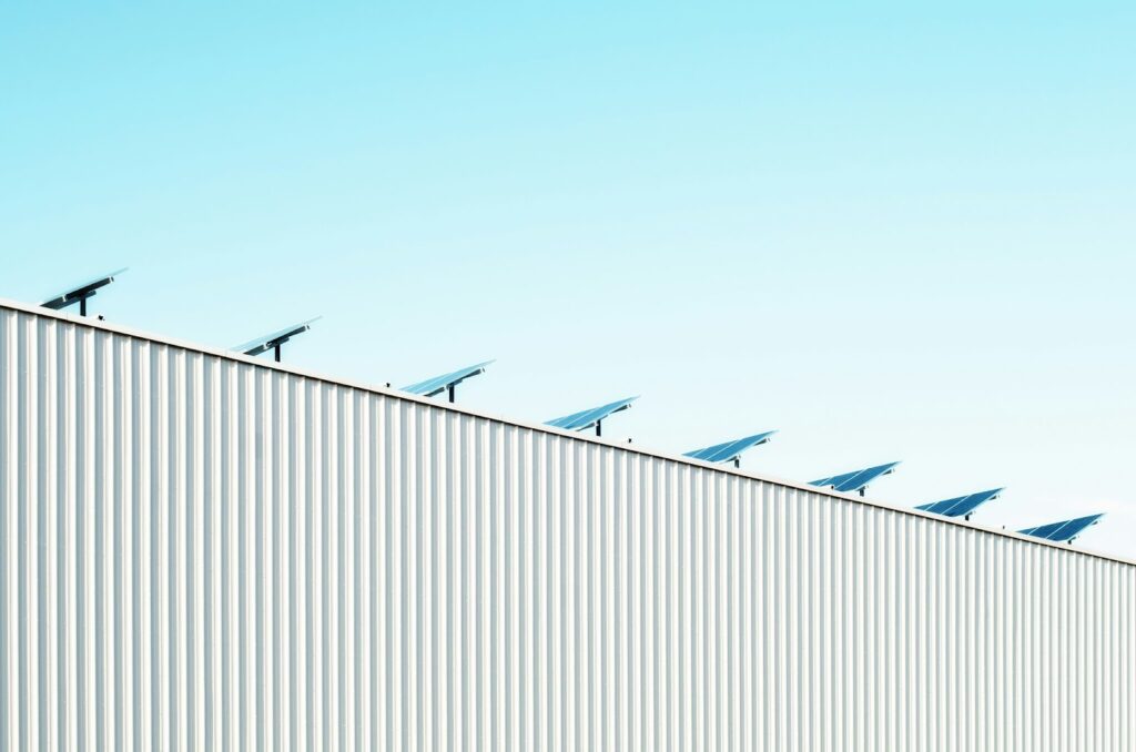 A metal warehouse with solar panels.