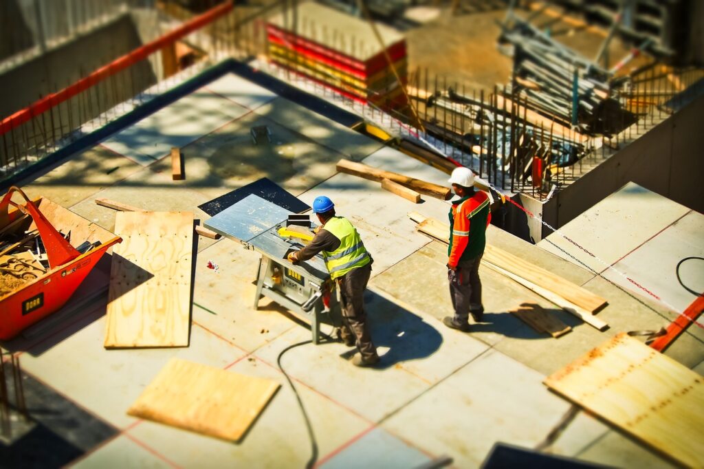 Two workers on a building construction site.