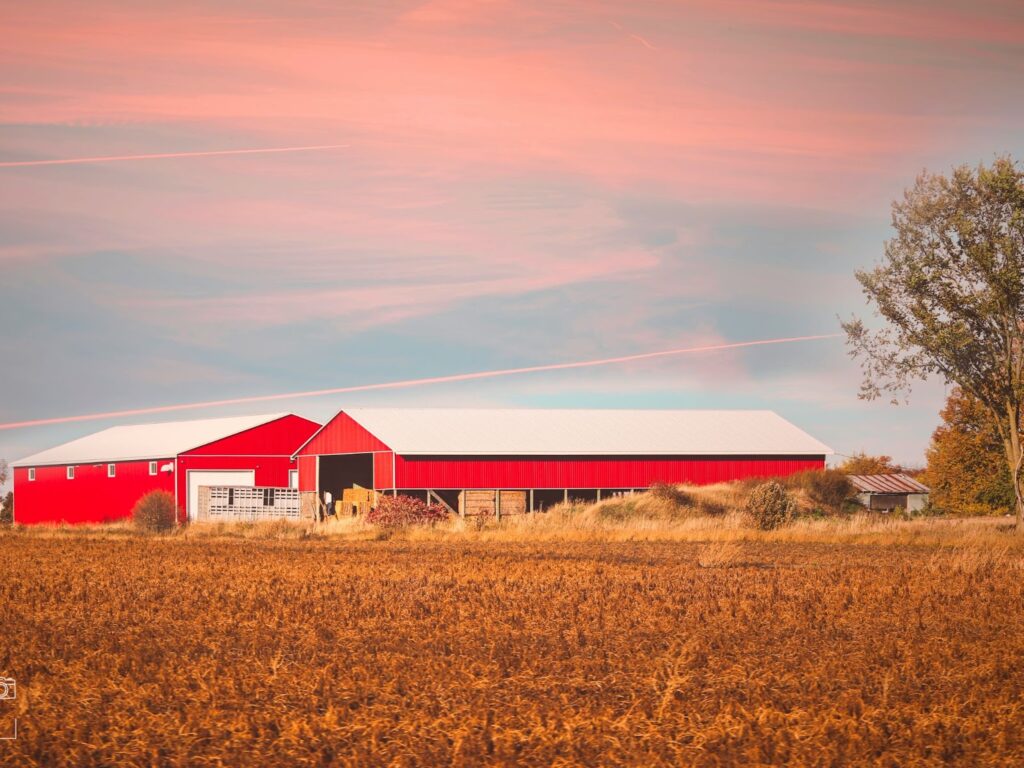 A metal barn filled with hay.