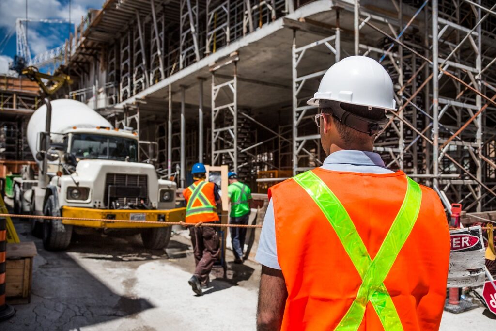 A construction site with workers and a cement truck.