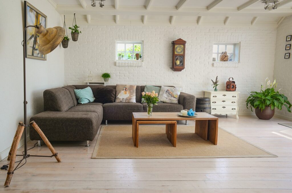 A barndominium living room with a couch, table, and plants.