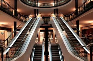 A shopping mall with several escalators.